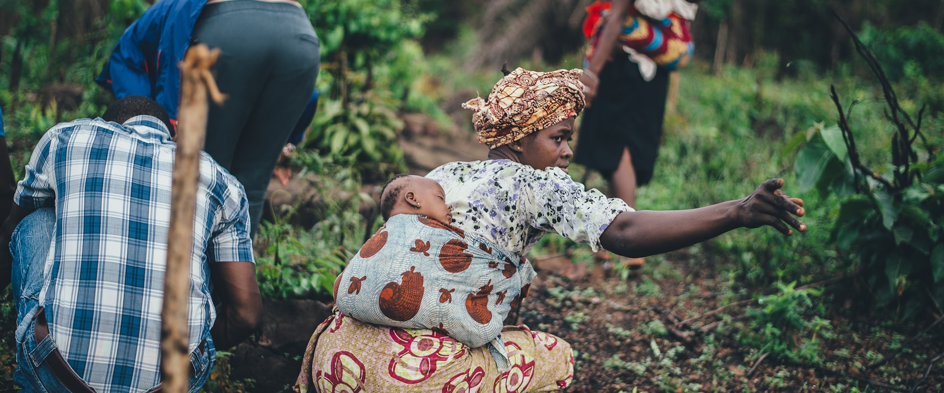 A woman tending crops on her land