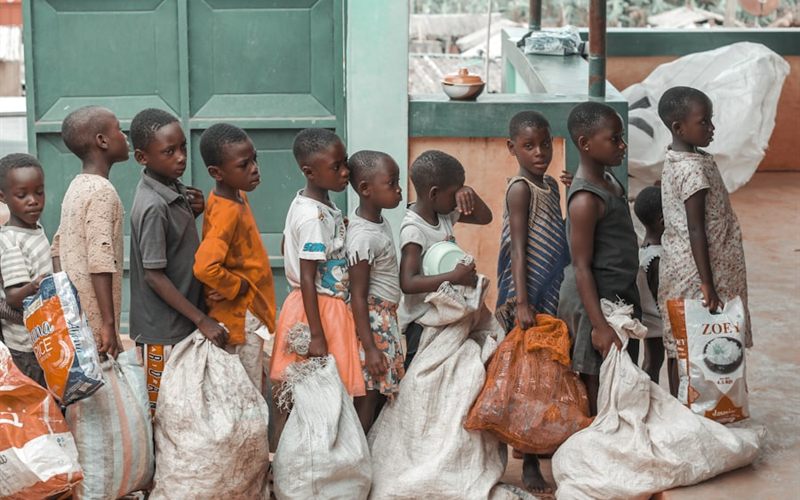 Children collecting sacks of relief supplies at a distribution point
