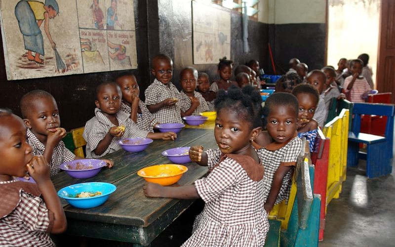 Children eating a meal together at a school table