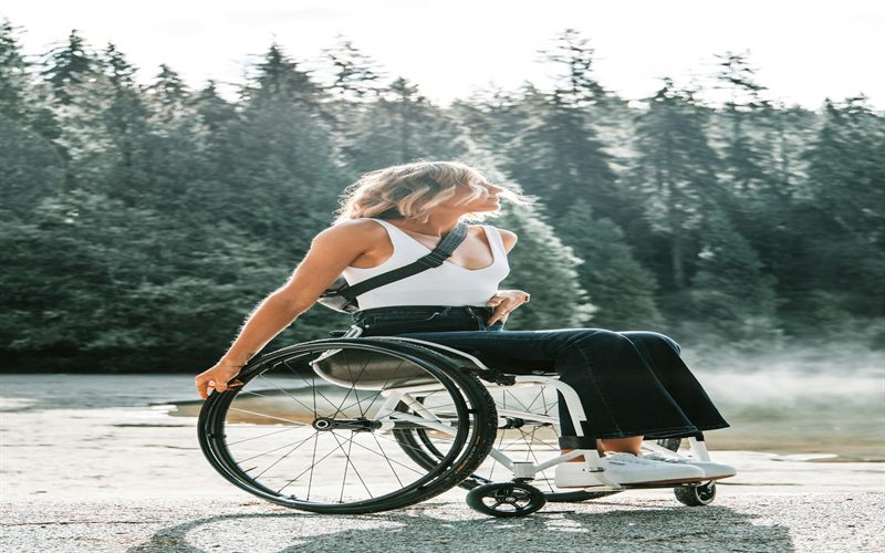 A person using a lightweight manual wheelchair