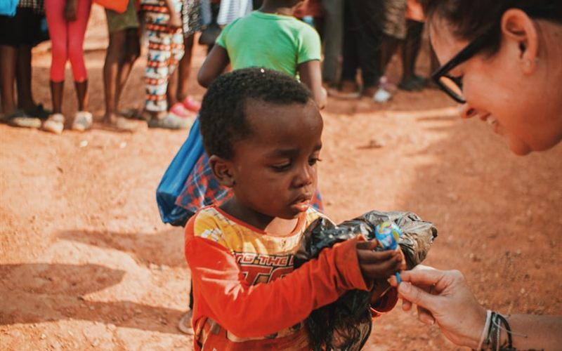 Supplies being handed to a child at a distribution point