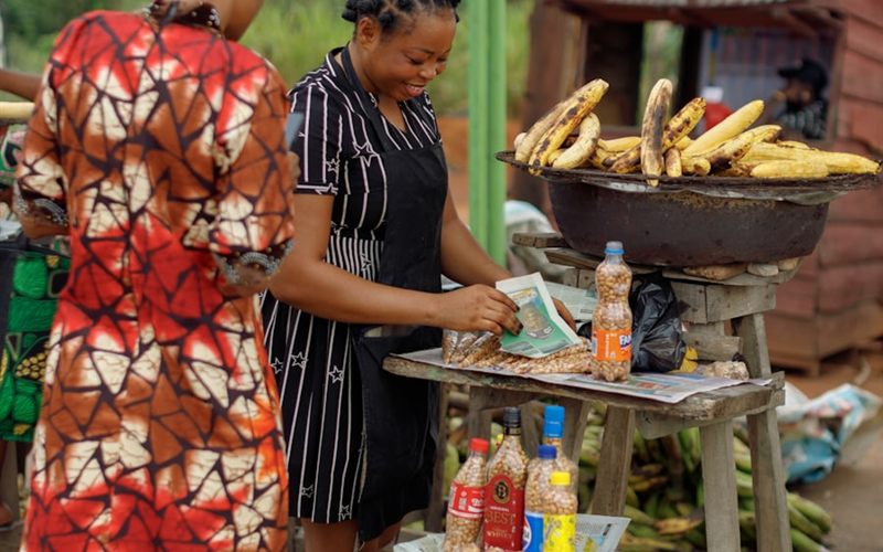 Two women running a food stall together at a market